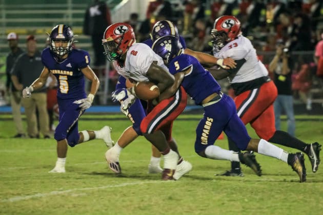 HHS Jordan Williams forces a fumble from QB Shadarian Harrison Photo Scott LaPrade