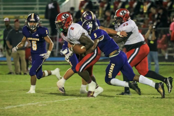 HHS Jordan Williams forces a fumble from QB Shadarian Harrison Photo Scott LaPrade