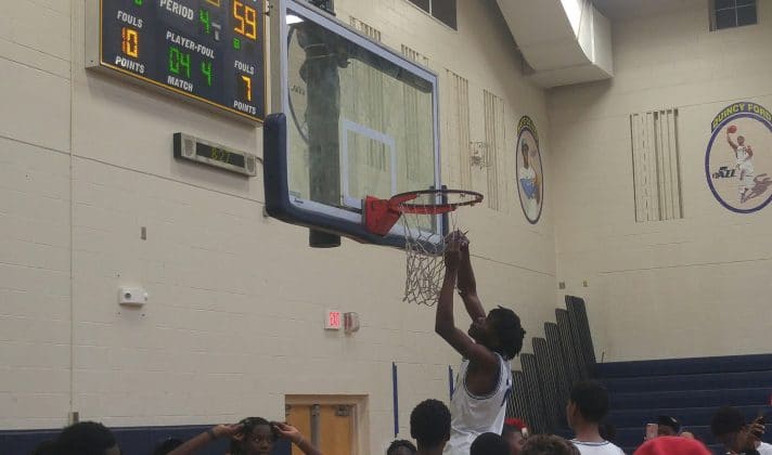 Gibbs player takes down the net as a momento after winning the Region Final against Central on Friday night Feb. 25, 2022. Photo by Austyn Szempruch.