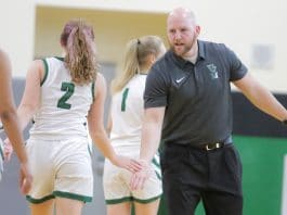 Weeki Wachee’s girls' varsity coach Billy Hughes congratulates the girls coming in for a time out. Photo by Alice Mary Herden