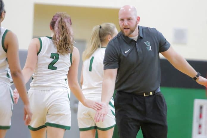 Weeki Wachee’s girls' varsity coach Billy Hughes congratulates the girls coming in for a time out. Photo by Alice Mary Herden