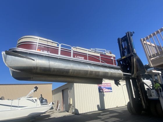 Boat being lifted and moved across the lot. Photo by Summer Hampton.