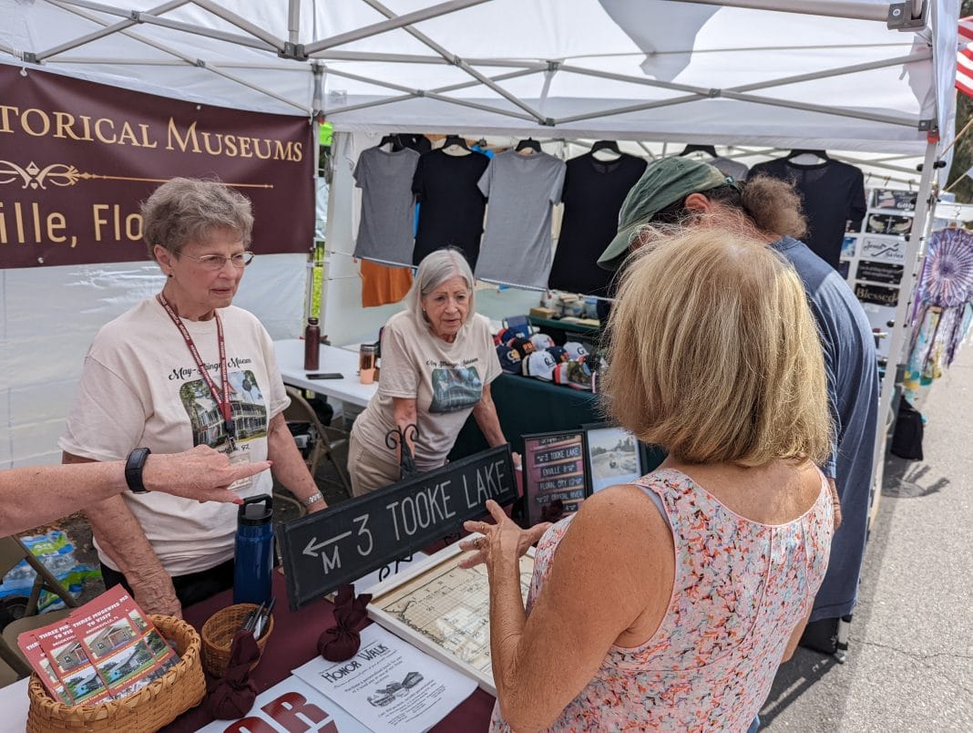 Hernando Historical Museum Association volunteers speaking with festival attendees