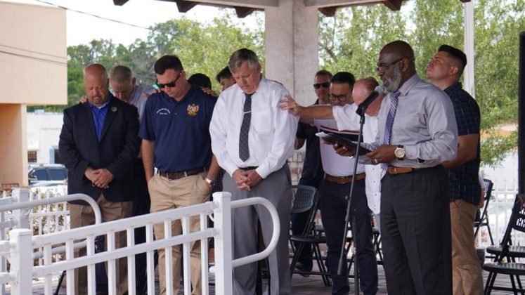 Pastor Dell Barnes (left front) prays for local government officials/ May 5, 2022 National Day of Prayer, Brooksville Commons / courtesy of Javen Mirabella