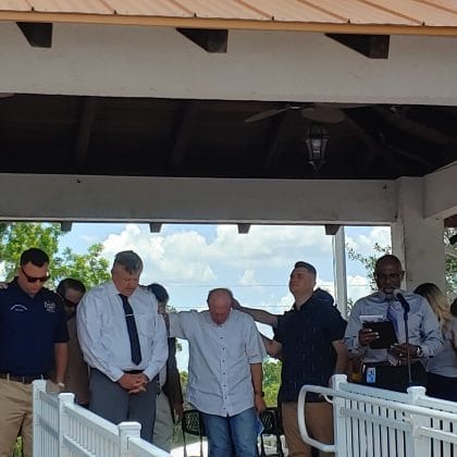 Pastor Dell Barnes (at the microphone) praying for local government officials/ May 5, 2022 National Day of Prayer, Brooksville Commons / Photo by Sarah Nachin