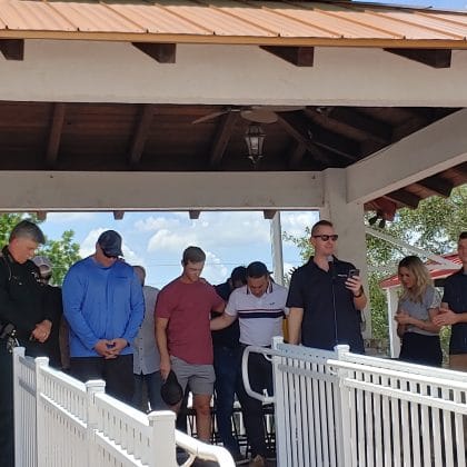 Pastor Daniel Norris (at the microphone) praying for First Responders/ May 5, 2022 National Day of Prayer, Brooksville Commons/ Photo by Sarah Nachin