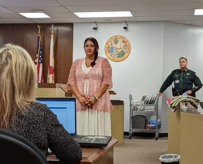 Angelica Vilardo receives congratulatory remarks upon her graduation from drug court.