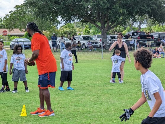 Tyrone Goodson runs passing drill with Tyrone Goodson Jr.