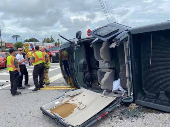 first responders at accident scene with pickup truck rolled over on its left side