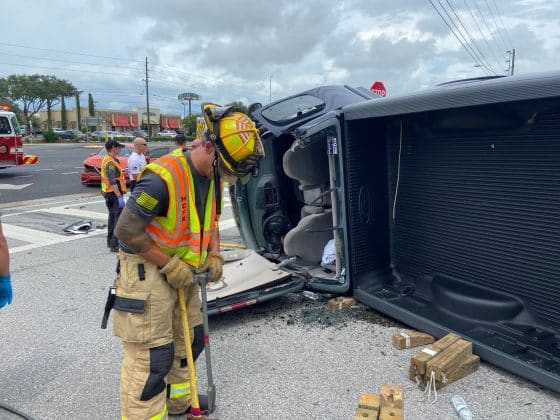 member of the hcfr team tends to accident scene with overturned pickup truck