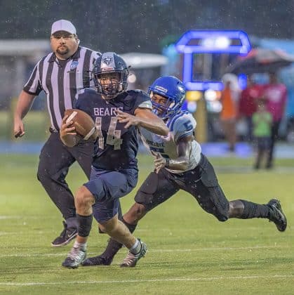 Central High, 14, Braden Joyner attempts to escape the pursuit of Anclote High’s ,5, Damien Spencer. Photo by JOE DiCRISTOFALO