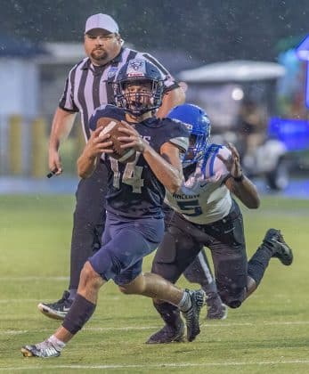 Central High, 14, Braden Joyner attempts to escape the pursuit of Anclote High’s ,5, Damien Spencer. Photo by JOE DiCRISTOFALO