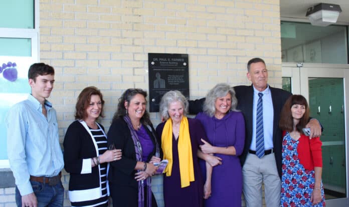 The family of Dr. Paul Farmer in front of the plaque commemorating his legacy at Hernando High School.