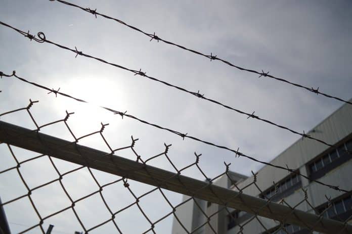 Barbed-wire fence/ prison image