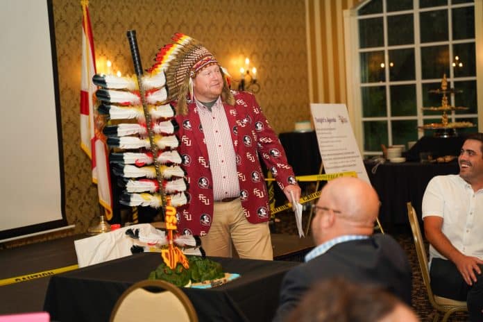 Jared Tanner presents his FSU-UF rivalry cake. Photo by Monocle Design Solutions.