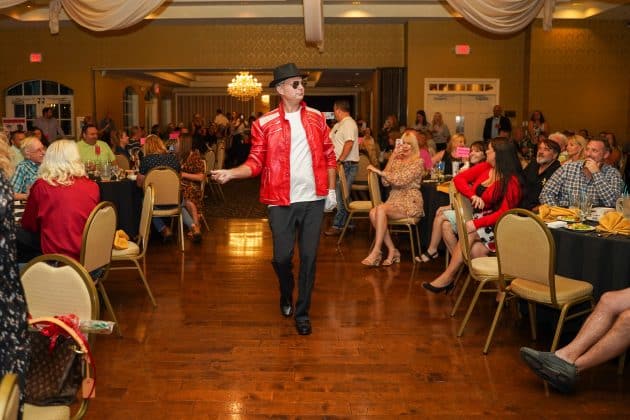 Andy Lyons works the crowd during his presentation of his Michael Jackson themed cake at the 7th Annual Men’s Bake fundraiser for affordable housing on Aug. 26, 2022. Photo courtesy of Monocle Design Solutions.