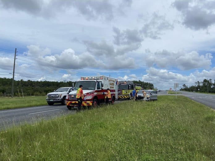 vehicle occupants inspect vehicle with first responders