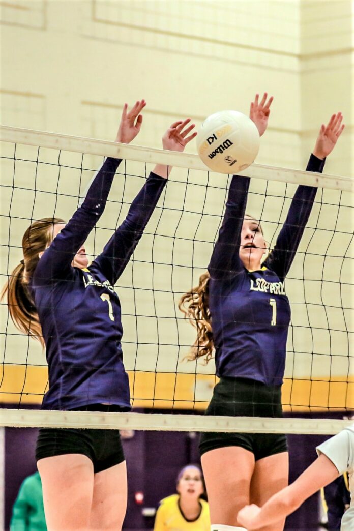 Lady Leopards (So) 1 Audrey Shpigel and (So) 7 Brooke Hart block the return ball from the Lecanto Panthers Thursday night on September 22, 2022 at Hernando.