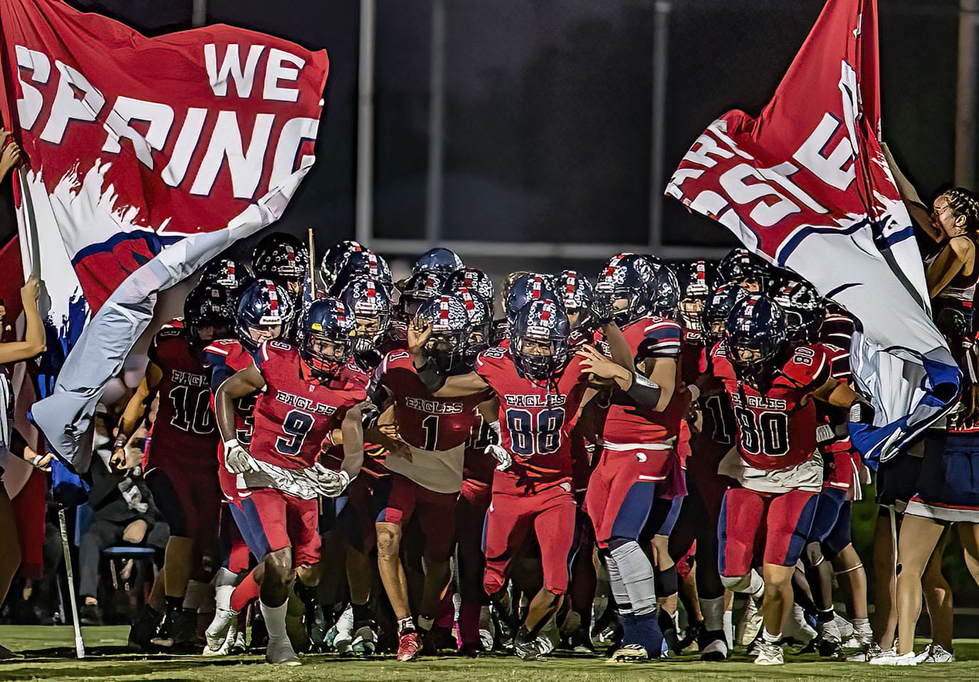 Springstead breaks the banner before the Homecoming game defending their perfect season record taking on Land O’ Lakes. Players include 9, Taylor Fussell, 88, Caidell Gilbert, and, 80, Michael Rizzutto. Photo by JOE DiCRISTOFALO
