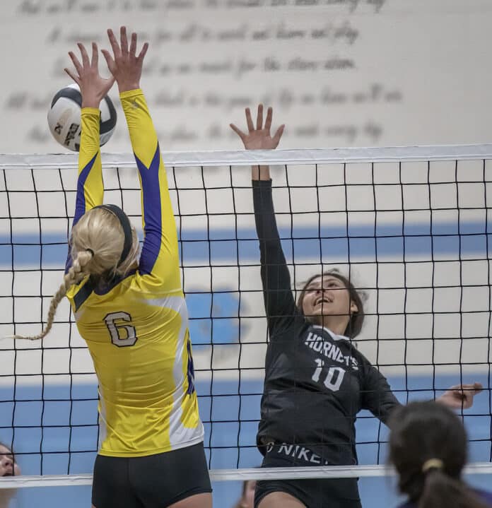 Hernando High, 6, Kaiya Ward attempts to block a volley by Weeki Wachee ,10, Jadyn Aponte in the 4A District 9 semi-final play off match at Nature Coast High. Photo by JOE DiCRISTOFALO