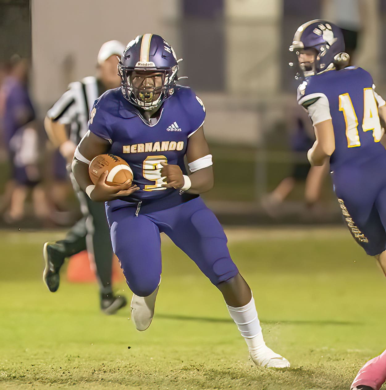 Hernando High running back John Capel III runs for a gain after taking a hand off from ,14, Michael Saltsman during the Homecoming game against Crystal River. Photo by JOE DiCRISTOFALO