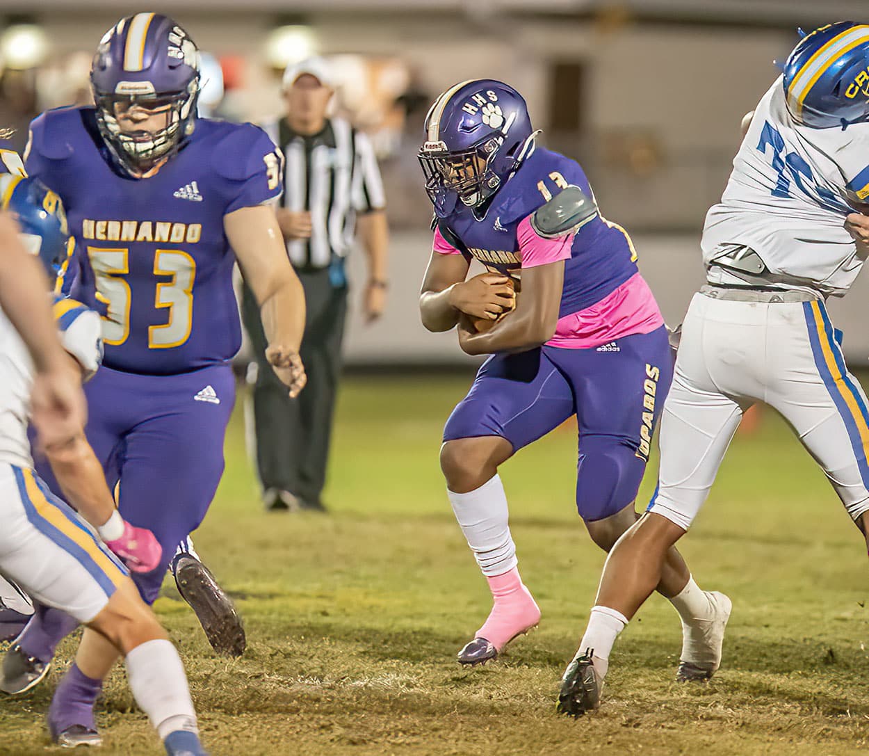 Hernando High running back , 13, Taurian Tucker follows blocking by ,53,Riley Nilsen during the Homecoming game against Crystal River. Photo by JOE DiCRISTOFALO