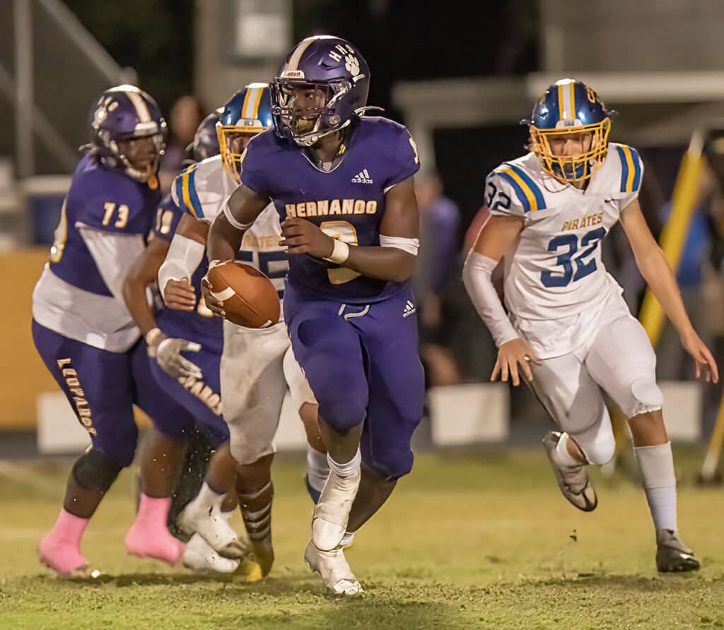 John Capel III looks downfield for an open receiver moments before completing a long touchdown pass to Leandre Wright during Hernando High’s Homecoming game against Crystal River. Photo by JOE DiCRISTOFALO