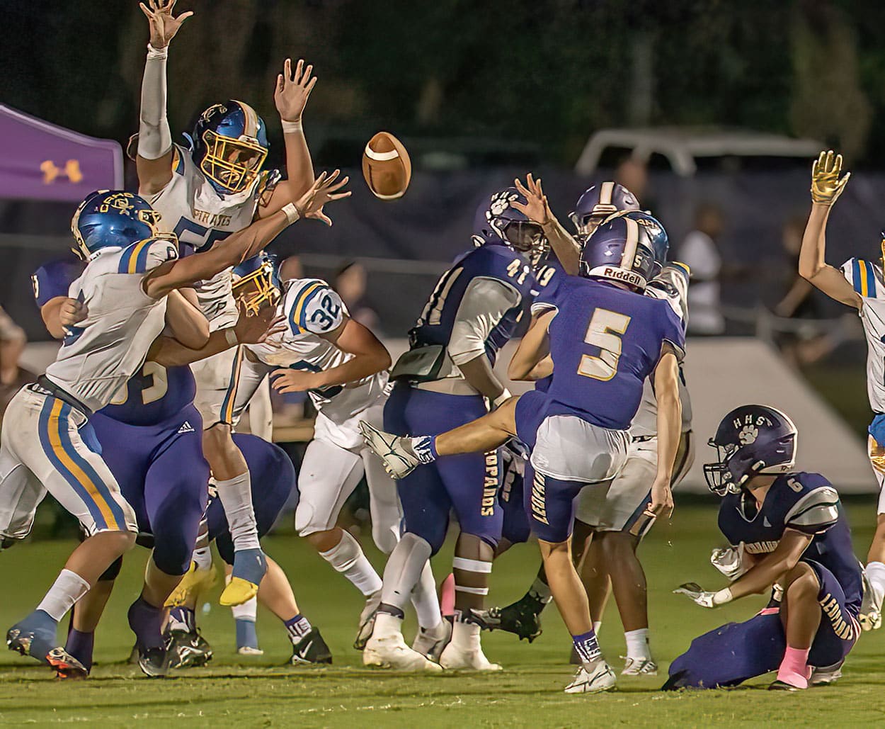 Hernando placekicker, 5, Jesse Faulks kicks an extra point despite the blocking attempt by Crystal River during the Homecoming game in Brooksville. The hold was by ,6, Emanuel Acker. Photo by JOE DiCRISTOFALO