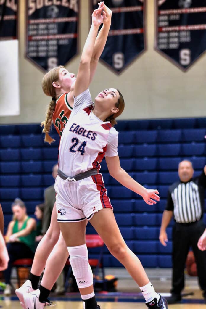 Tuesday night at Springstead November 22, 2022. The Seminole Warhawks took on the Eagles. Eagles 24 Sr. Isavbella Paul goes head to head with Warhawks 25 Jr Devone Swartz for the start of the game. Photo by Cheryl Clanton.