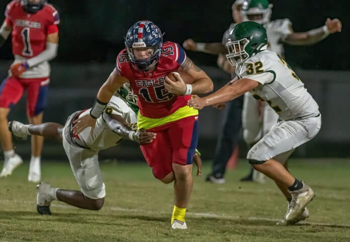 Springstead QB ,15, Ayden Ferguson breaks through the Lecanto defense on a keeper play during a scoring drive Friday at Booster Stadium. Photo by JOE DiCRISTOFALO