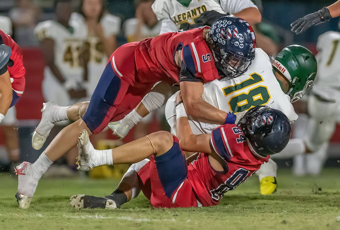 Madden Baratczuk, 5, and 84, Brenden Hoepker wrap up the Lecanto QB during the first half Friday at Springstead High.Photo by JOE DiCRISTOFALO.