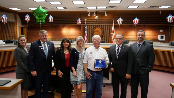 Recognizing outgoing commissioner Wayne Dukes.