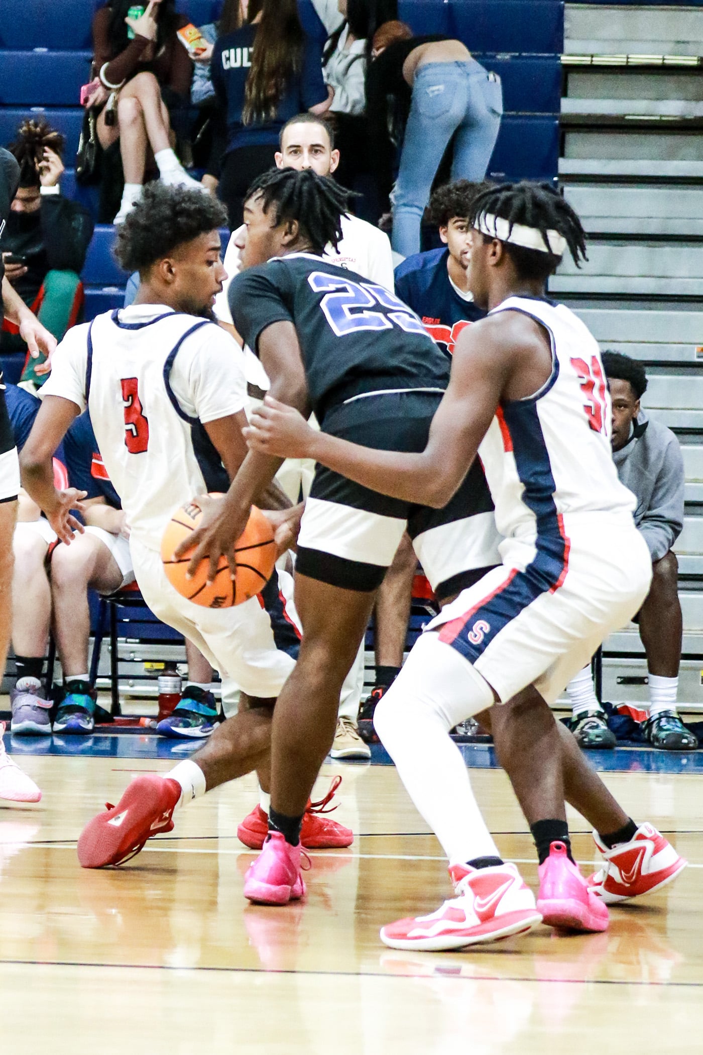Thursday night 12/1 Eagles #3 Senior Divine Torain and #31 So. Zion McKenzie on defense to get control of ball from Central #25 Junior Tykel Williams. Photo by Cheryl Clanton.