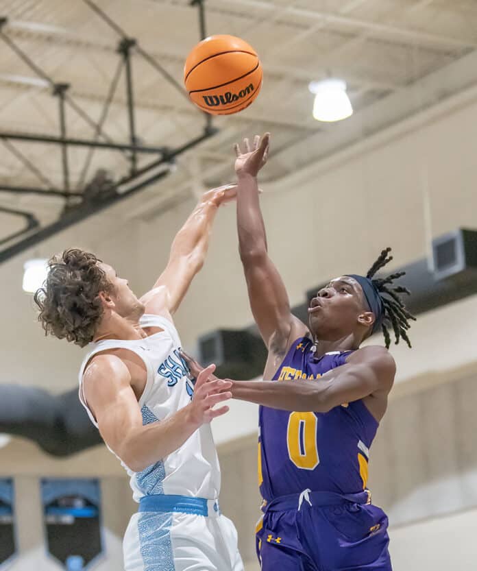 Hernando High, 0, Liandre Wright shoots over the defense by NCT ,14, Canyon Anderson during the match Tuesday at Nature Coast Tech. Photo by JOE DiCRISTOFALO