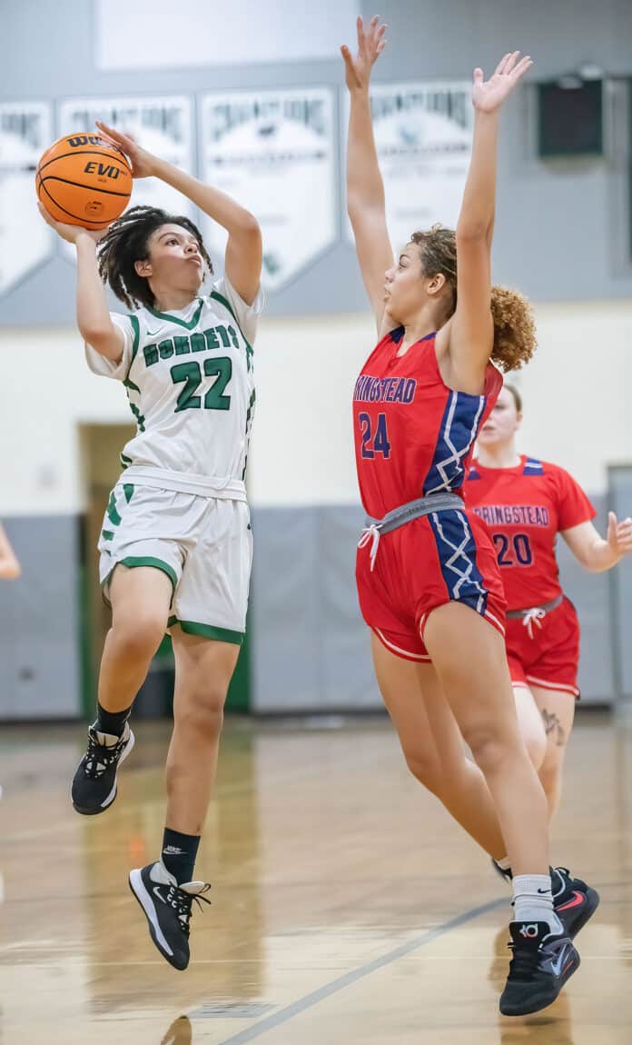 Weeki Wachee ,22, Rayana Coleman shoots over Springstead ,24, Isabella Paul at Weeki Wachee High. Photo by JOE DiCRISTOFALO