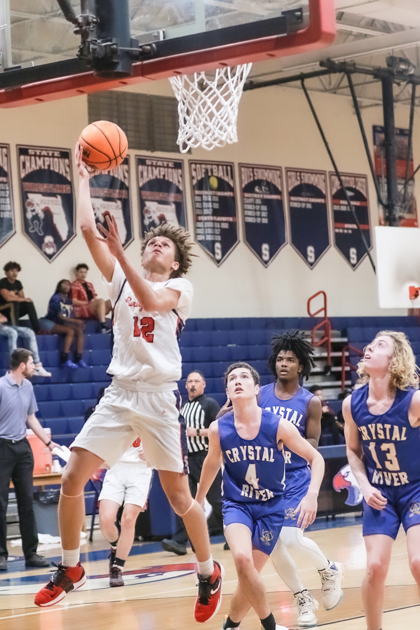 Eagles' #12 Jr. Austin Nicholson takes the ball down court and goes in for the point against Crystal River Tuesday night. Photos by Cheryl Clanton.