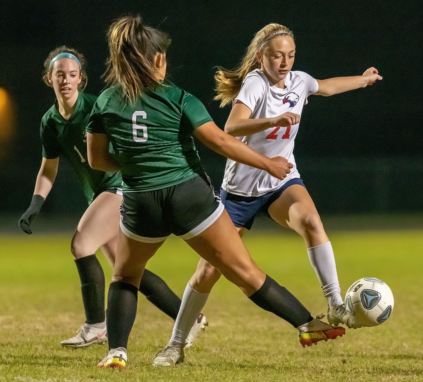 Springstead High Norah Williams ,27 attempts to elude the defense by Weeki Wachee ,6, Jade Euceda and ,1, Madison Wilkes 1/10/23 Tuesday night. Photo by JOE DiCRISTOFALO