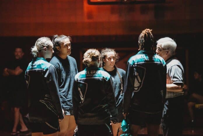 Hernando Girls Team Captains Grace Leota and Daniela Espinal meet Bell Creek Academy at the center of the mat. Photo by Cynthia Leota.