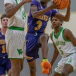 Hernando High, 3, Josiah Wright looks for a path to the basket guarded by Weeki Wachee, 24, Anthony Wilson Tuesday night at Weeki Wachee High. Photo by JOE DiCRISTOFALO