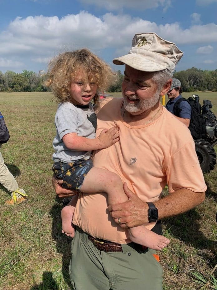 JJ Rowlands is carried by Roy Link, one of the volunteers who found him. Photo by HCSO.