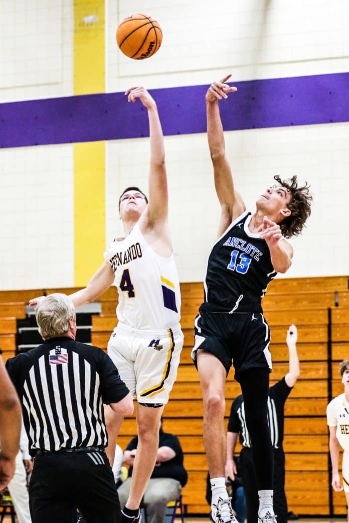 Tuesday night February 2, 2023 Boys Basketball District Quarterfinal. Anclote vs HHS. Start of game with Anclote #13 vs HHS #4 Senior Will Tigue. Photo by Cheryl Clanton.