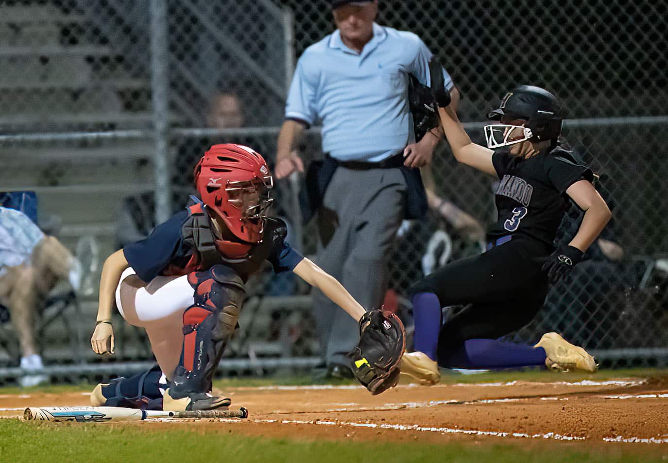 Hernando High ,3, Aryanna Eliopoulos slides into home just ahead of a tag attempt by Springstead catcher, Rachel Rivera Thursday at Springstead High. Photo by JOE DiCRISTOFALO