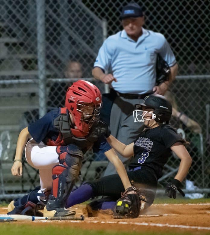 Hernando High ,3, Aryanna Eliopoulos slides into home just ahead of a tag attempt by Springstead catcher, Rachel Rivera Thursday at Springstead High. Photo by JOE DiCRISTOFALO