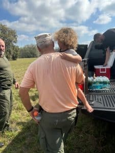 Roy Link carries JJ to awaiting First Responders. Photo Credit: Trish Graeme