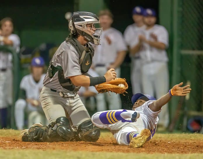 Hernando High’s Henry Robinson slides safely into third base Tuesday night in the home game versus Weeki Wachee. Photo by JOE DiCRISTOFALO