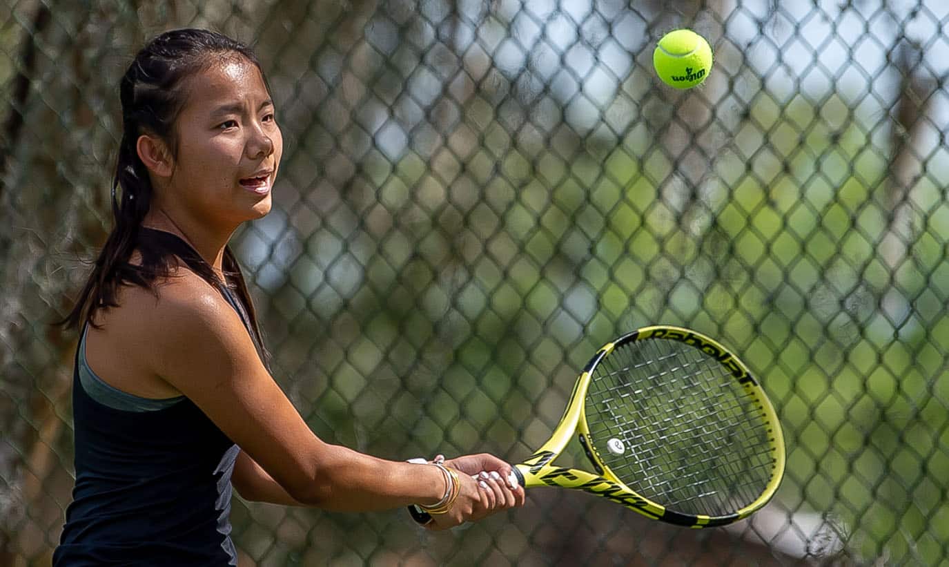 Hernando High’s Mia Liu concentrates on a backhand return in a doubles match versus Central High at Brooksville Park Tuesday afternoon. Photo by JOE DiCRISTOFALO