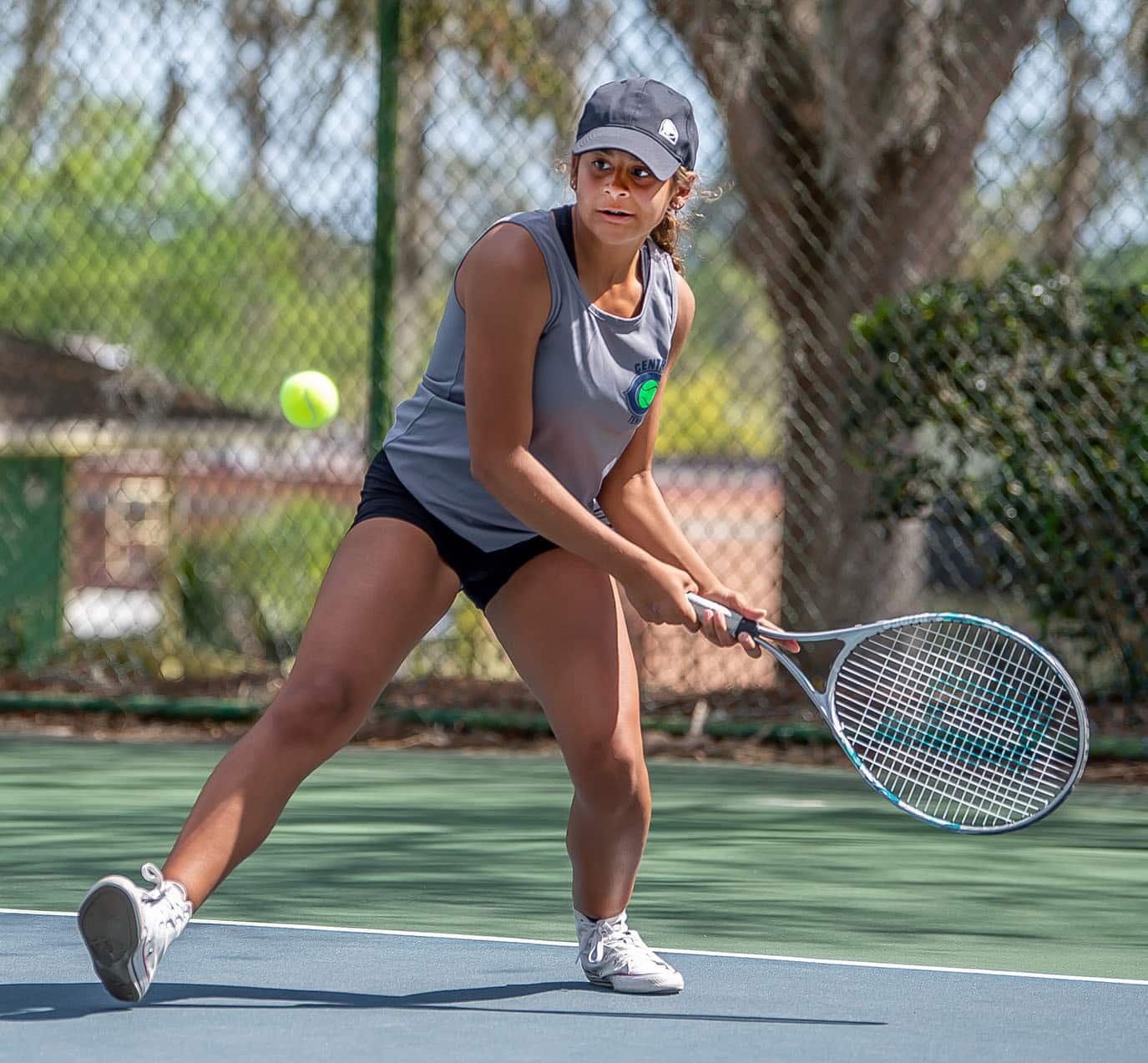 Central High’s Zioneliz Miranda-Perez eyes her target for a backhand return in a doubles match with Hernando High Tuesday in Brooksville. Photo by JOE DiCRISTOFALO