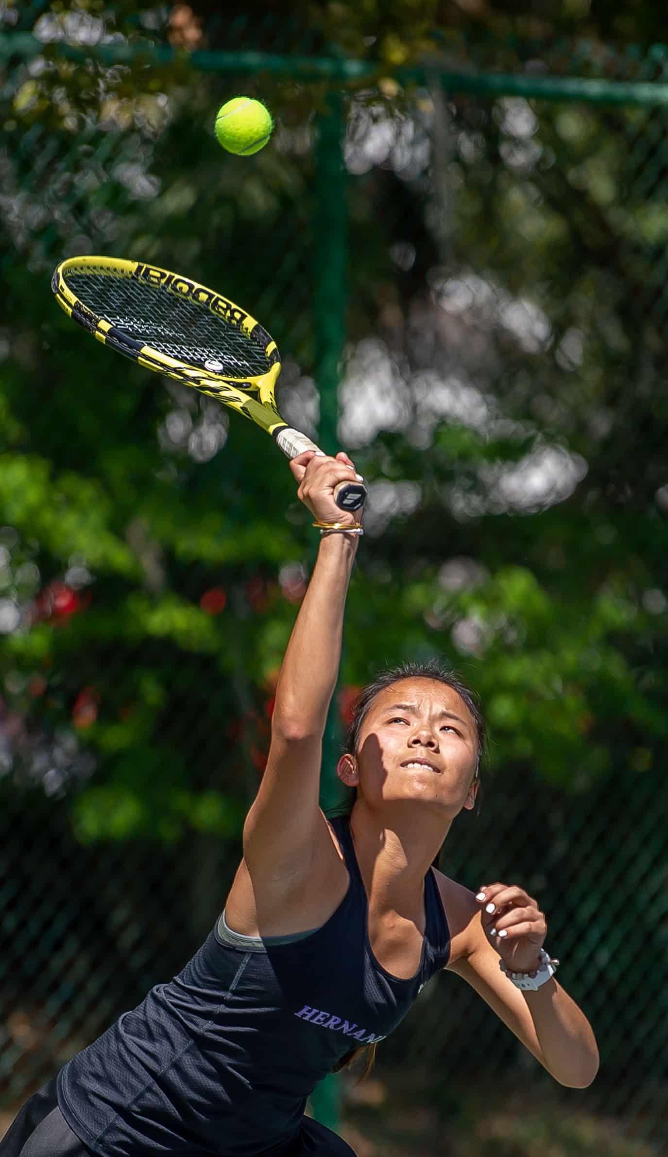 Hernando High’s Mia Liu concentrates during a serve in a doubles match versus Central High at Brooksville Park Tuesday afternoon. Photo by JOE DiCRISTOFALO