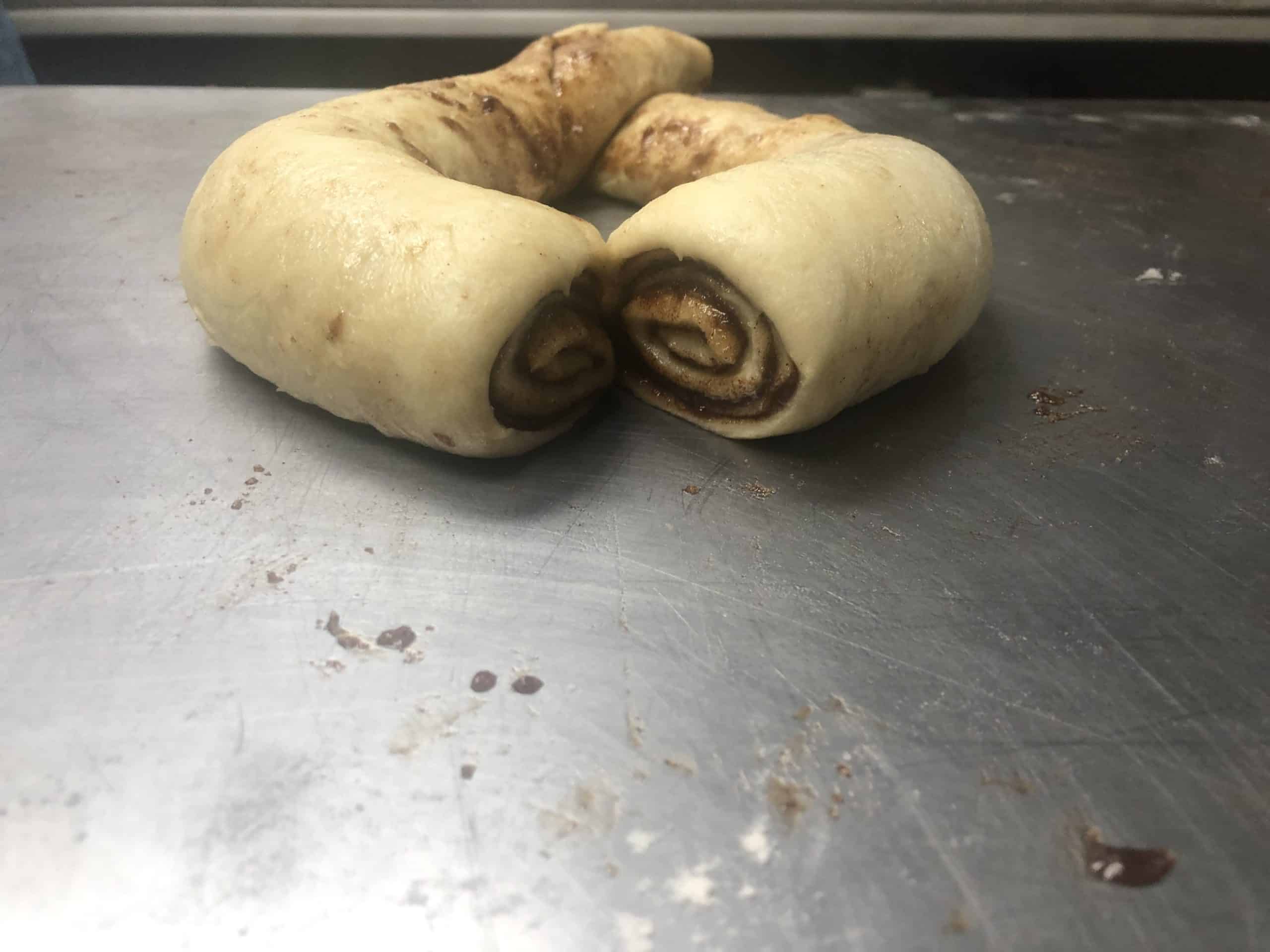 A rolled cinnamon babke which will then be folded into a baking tin.