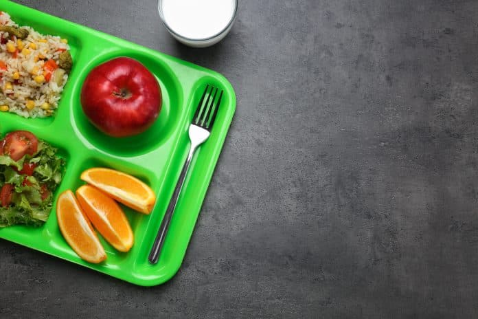 Serving tray with delicious food on table.